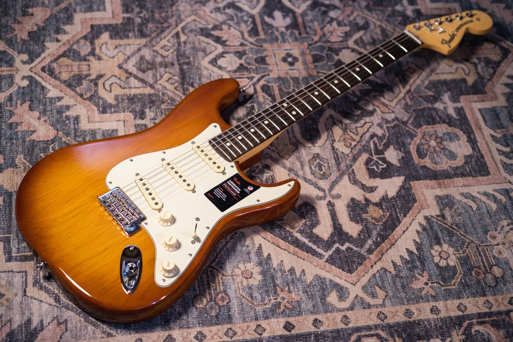 Photo of a Fender American Performer laying on a patterned rug